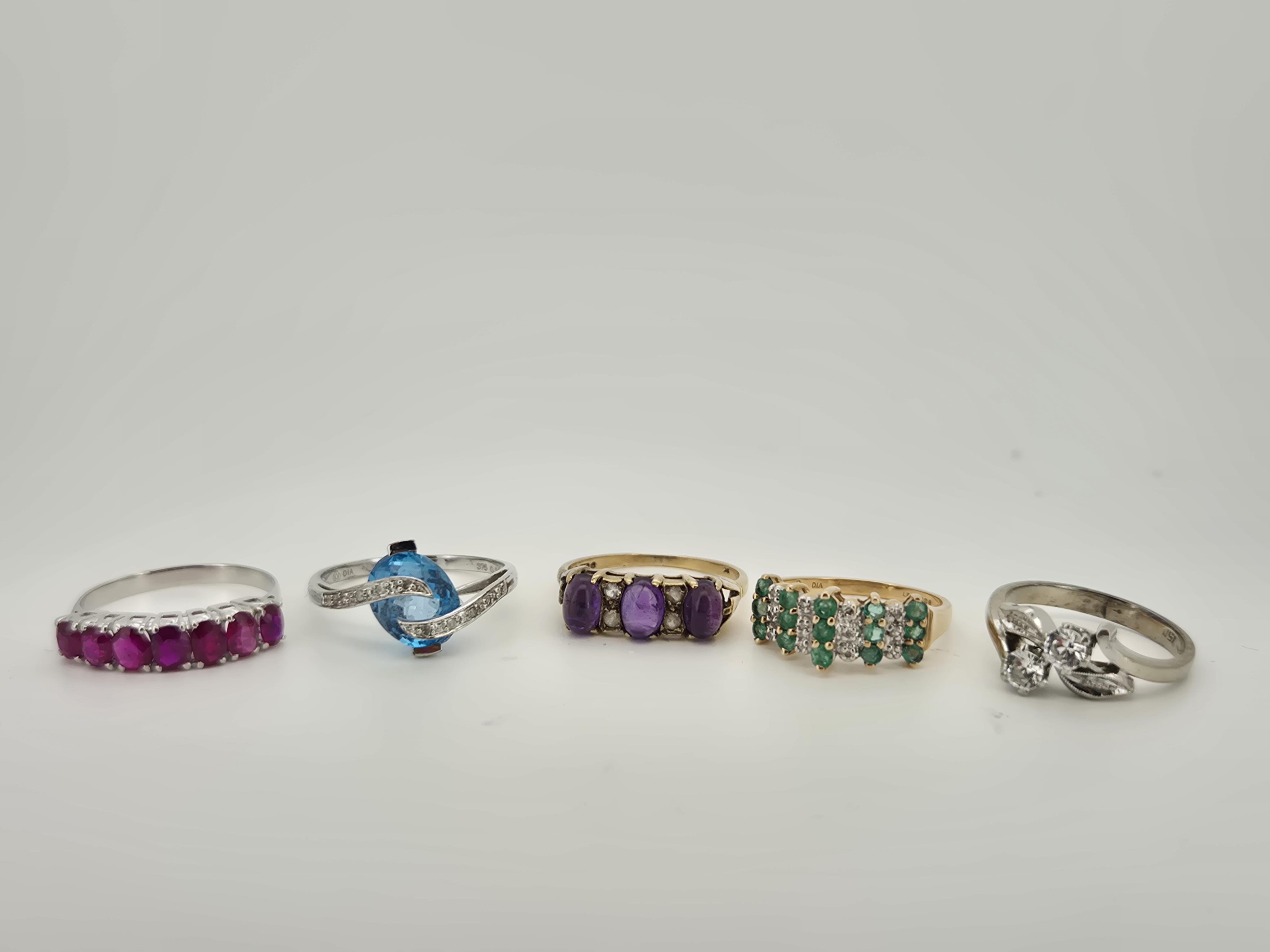 Three assorted modern 9ct gold and gem set rings, to include emerald and diamond cluster, blue topaz and diamond chip and cabochon amethyst, gross weight 6.7 grams, an unmarked white metal and graduated seven stone ruby